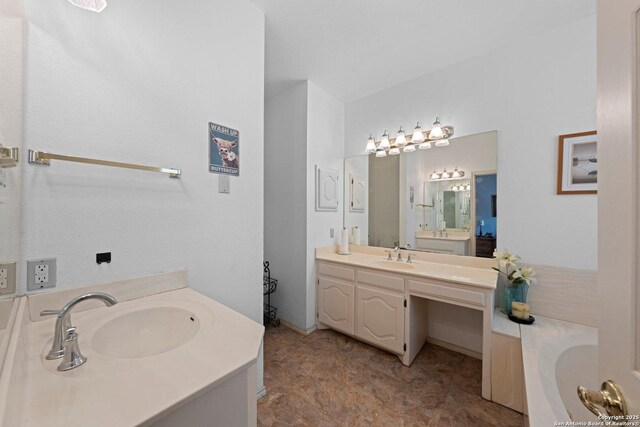 239 Old Oaks, Kerrville, TX 78028 - bathroom featuring two vanities and a bath