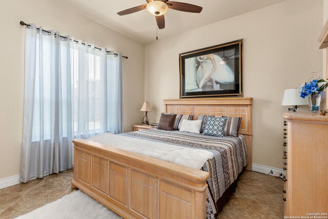 bedroom featuring baseboards and ceiling fan