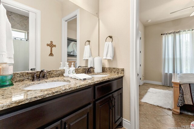 bathroom with double vanity, tile patterned floors, and a ceiling fan