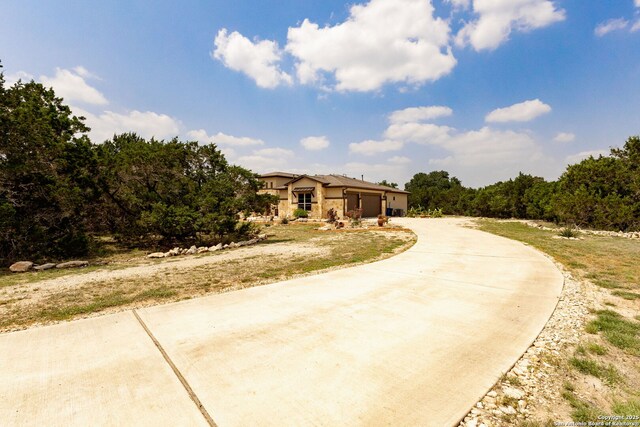 southwest-style home featuring concrete driveway and an attached garage