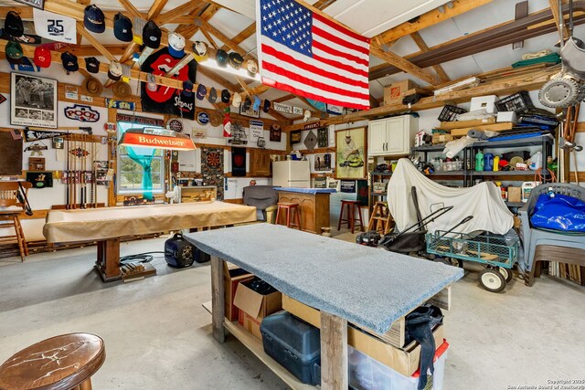 interior space with a workshop area and freestanding refrigerator