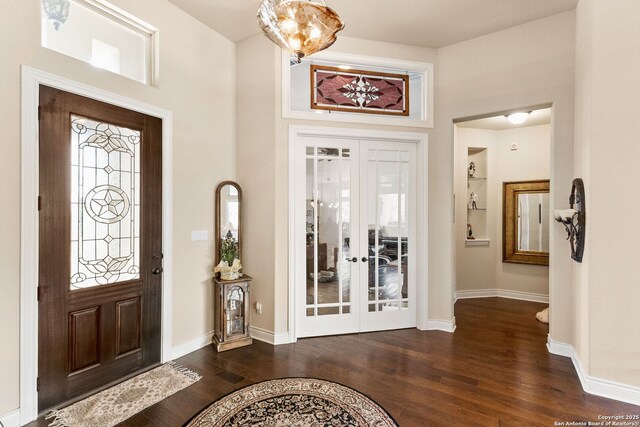 foyer featuring french doors, wood finished floors, and baseboards