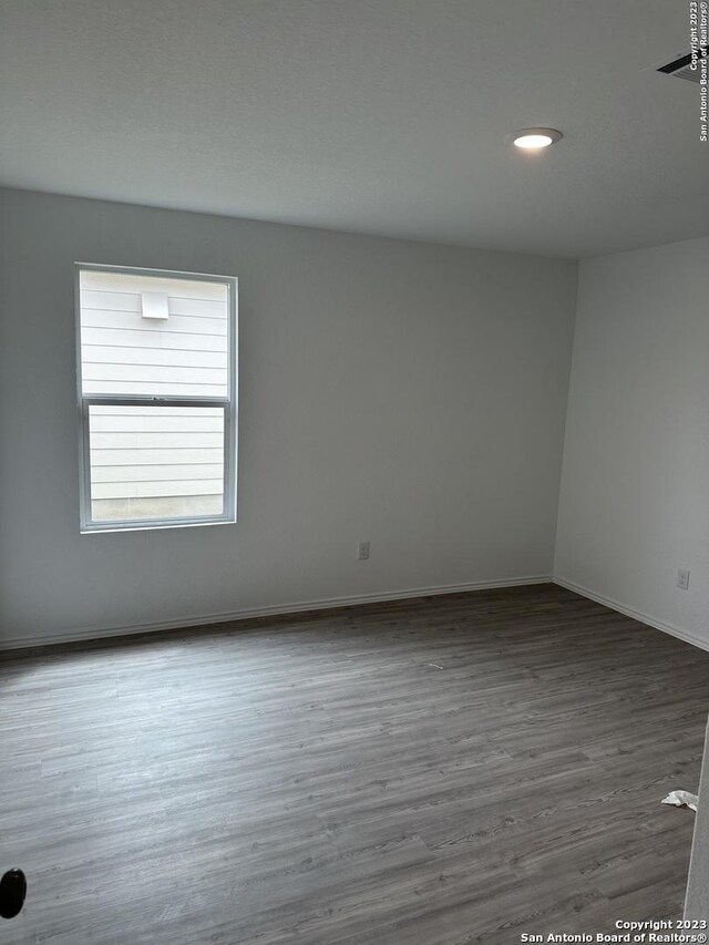 10742 Hernando Ct, Converse, TX 78109 - empty room featuring wood finished floors, baseboards, and recessed lighting