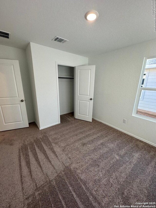 10742 Hernando Ct, Converse, TX 78109 - unfurnished bedroom featuring carpet flooring, baseboards, and a closet