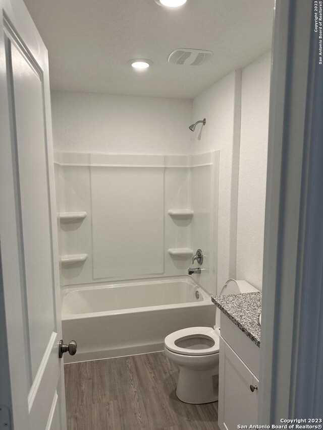 10742 Hernando Ct, Converse, TX 78109 - full bath with wood finished floors, toilet, shower / tub combination, and vanity