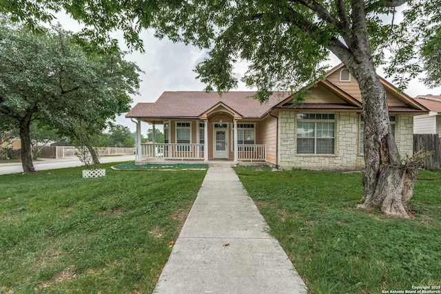 ranch-style home with covered porch, stone siding, and a shingled roof