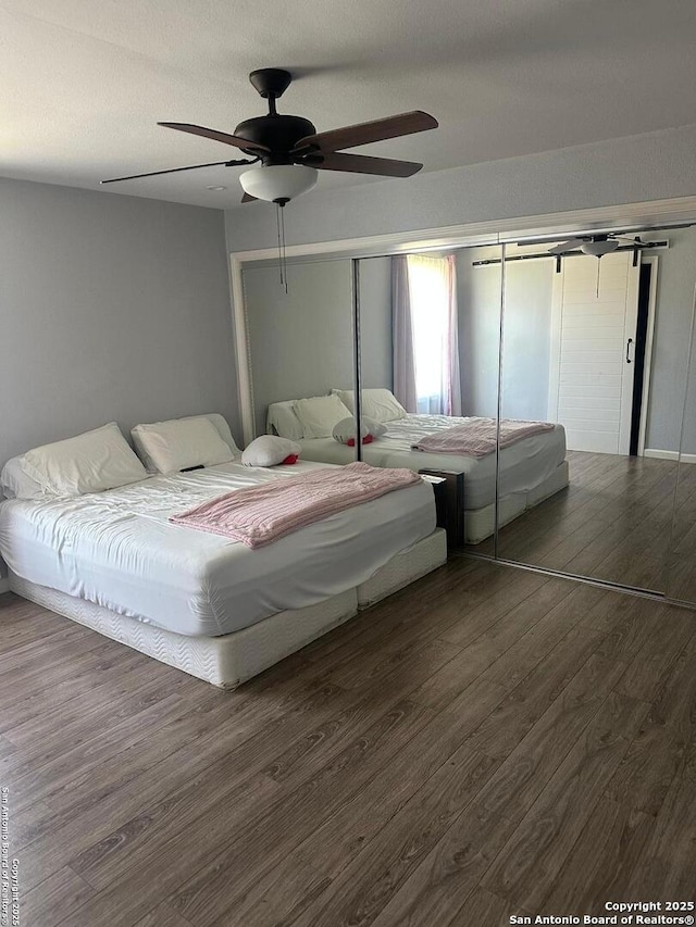 bedroom with wood finished floors and a ceiling fan