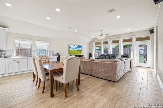 14327 Running Wolf, San Antonio, TX 78245 - dining space featuring light wood-style floors, ceiling fan, recessed lighting, and vaulted ceiling