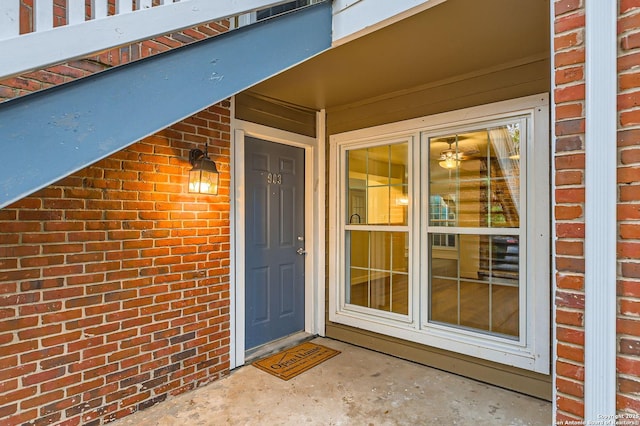 entrance to property featuring brick siding