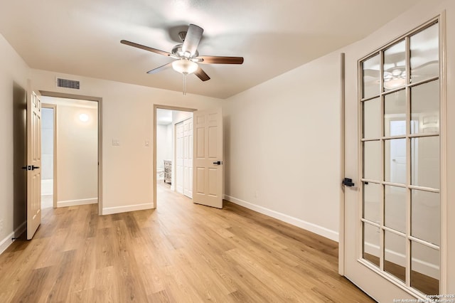 unfurnished bedroom with baseboards, light wood finished floors, and ceiling fan