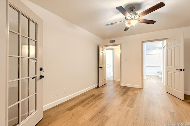 unfurnished bedroom with baseboards, light wood-type flooring, and a ceiling fan
