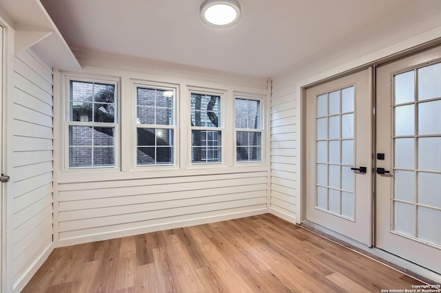 unfurnished sunroom with french doors
