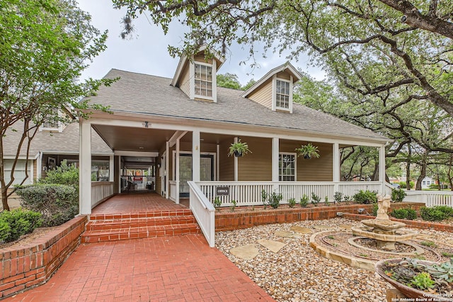 farmhouse-style home featuring a shingled roof and a porch