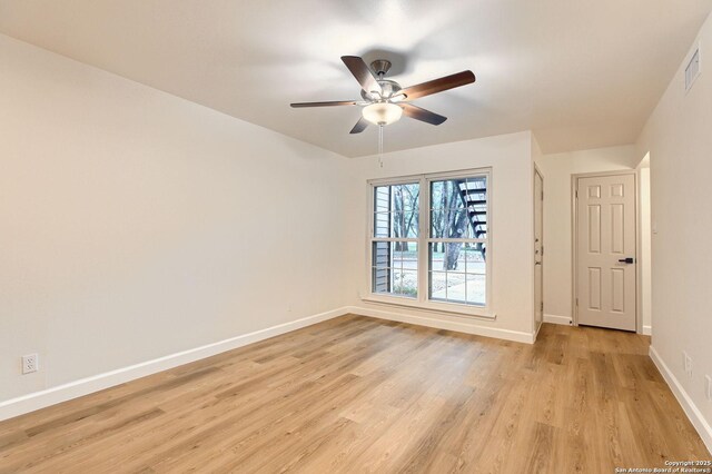 unfurnished room with light wood finished floors, baseboards, and ceiling fan