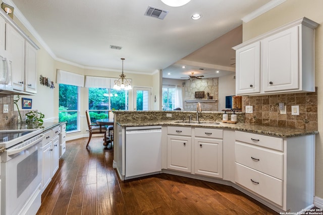 9347 Llano Verde, Helotes, TX 78023 - kitchen with white appliances, a peninsula, a sink, backsplash, and white cabinetry