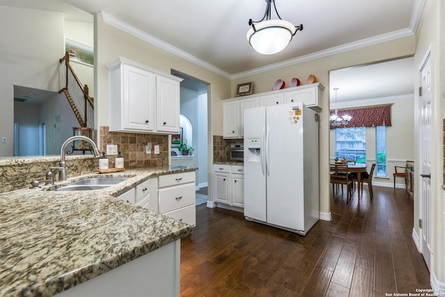 9347 Llano Verde, Helotes, TX 78023 - kitchen with white fridge with ice dispenser, a sink, a chandelier, light stone counters, and white cabinetry