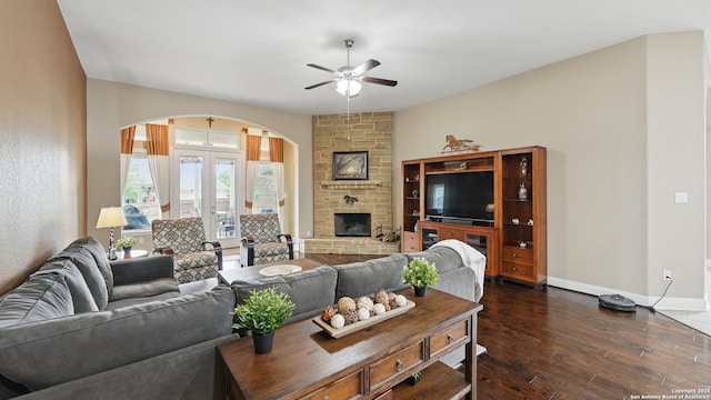 3318 Jasons, Marion, TX 78124 - living room with arched walkways, ceiling fan, dark wood-type flooring, baseboards, and a stone fireplace