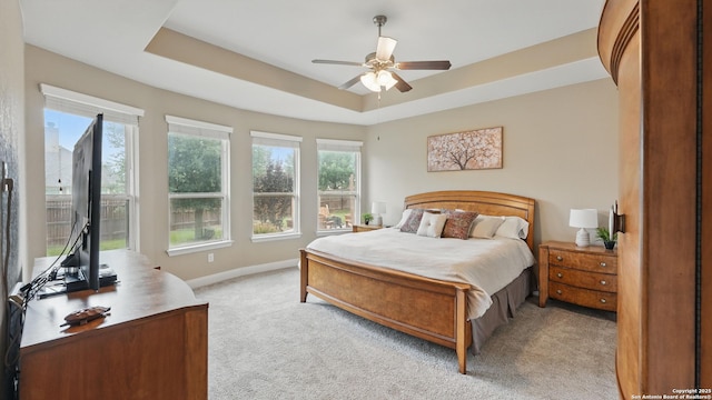 3318 Jasons, Marion, TX 78124 - bedroom featuring multiple windows, light carpet, a raised ceiling, and baseboards