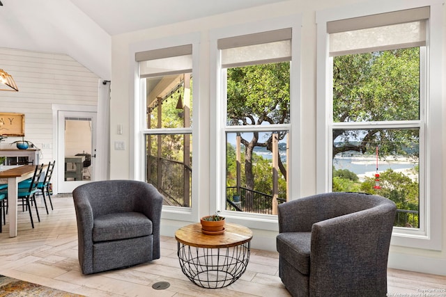 sitting room featuring plenty of natural light and wood walls