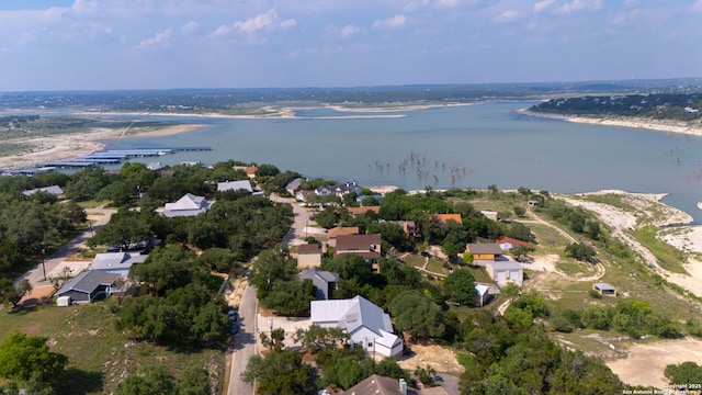 aerial view of property's location featuring a nearby body of water and nearby suburban area