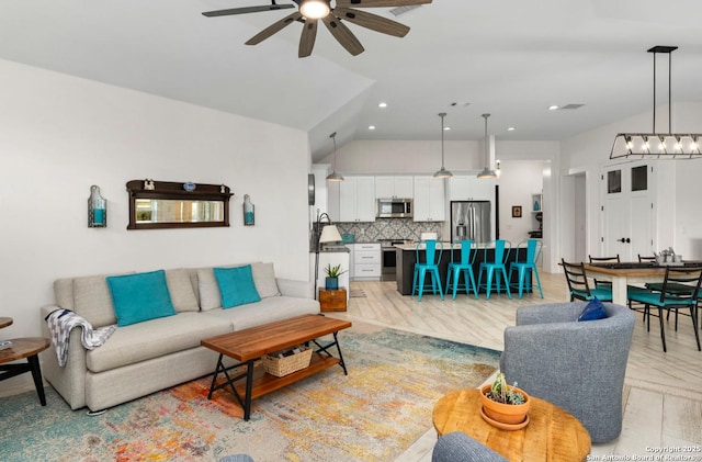 living room with ceiling fan, recessed lighting, and vaulted ceiling