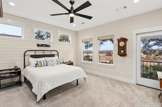 bedroom with carpet flooring, access to outside, recessed lighting, baseboards, and wood walls