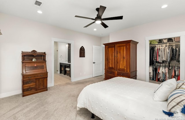 bedroom with light colored carpet, a closet, baseboards, recessed lighting, and connected bathroom