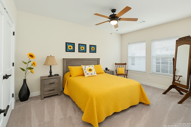 carpeted bedroom featuring baseboards and a ceiling fan