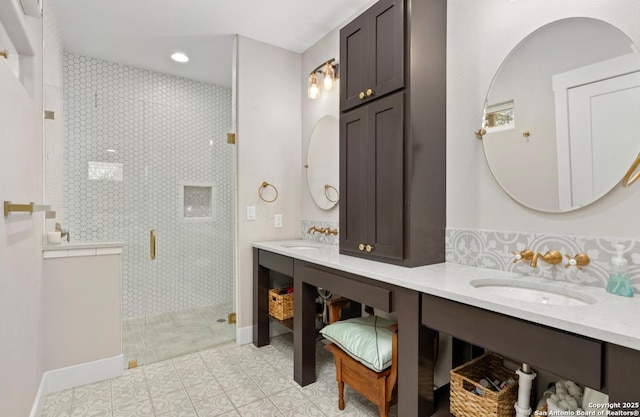 full bath with a stall shower, recessed lighting, double vanity, baseboards, and tile patterned flooring