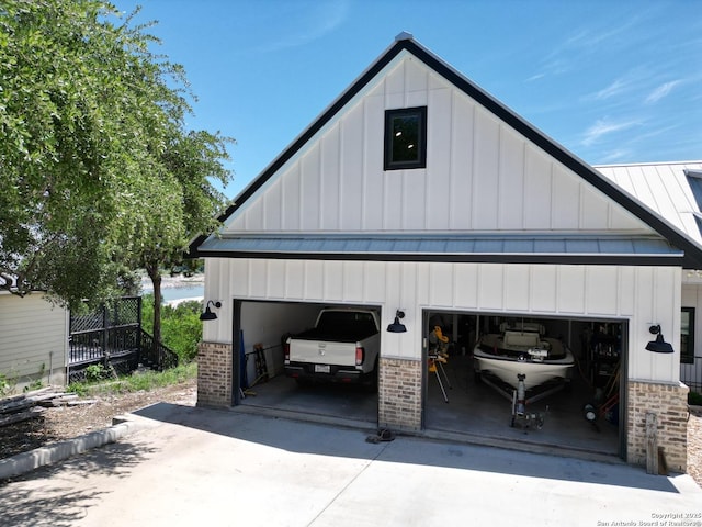 garage featuring concrete driveway