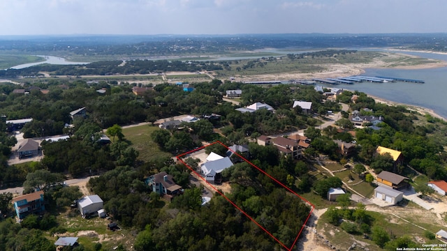 aerial overview of property's location with property parcel outlined and a nearby body of water