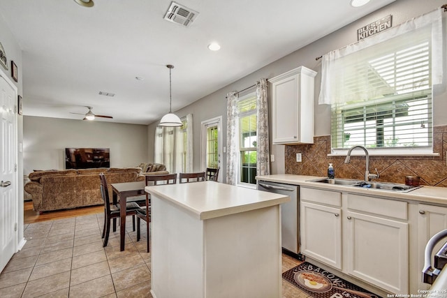 141 Glen Eagles, Cibolo, TX 78108 - kitchen with a sink, dishwasher, decorative backsplash, a kitchen island, and white cabinets