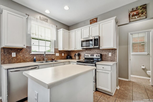 141 Glen Eagles, Cibolo, TX 78108 - kitchen featuring stainless steel appliances, a sink, white cabinetry, backsplash, and recessed lighting