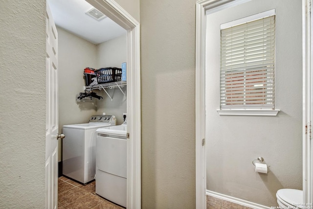 141 Glen Eagles, Cibolo, TX 78108 - clothes washing area with dark tile patterned floors and washer and clothes dryer