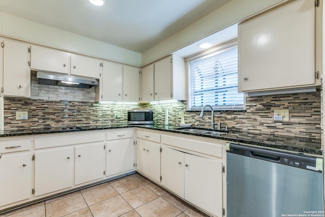 111 Cotillion, Castle Hills, TX 78213 - kitchen featuring appliances with stainless steel finishes, a sink, light tile patterned floors, under cabinet range hood, and tasteful backsplash