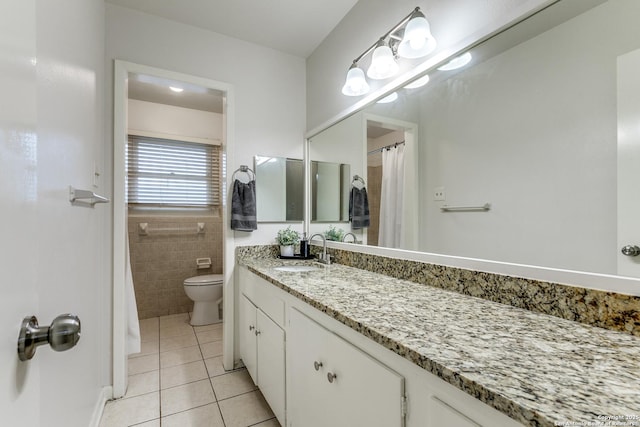 111 Cotillion, Castle Hills, TX 78213 - bathroom featuring tile patterned flooring, toilet, vanity, tile walls, and a shower with shower curtain