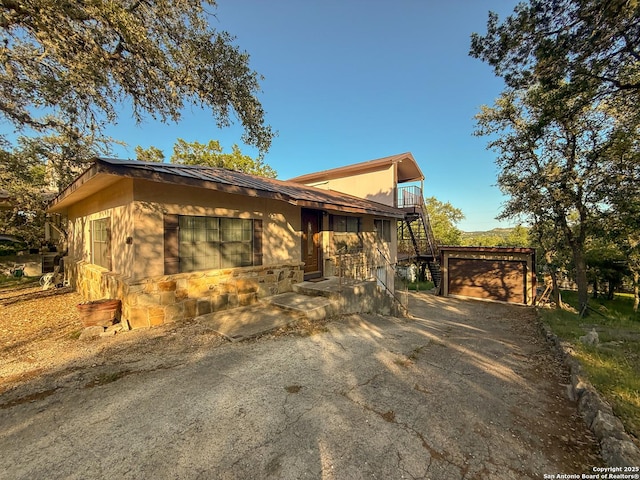 3084 Rustler, Canyon Lake, TX 78133 - view of side of property featuring a garage, stairs, and driveway