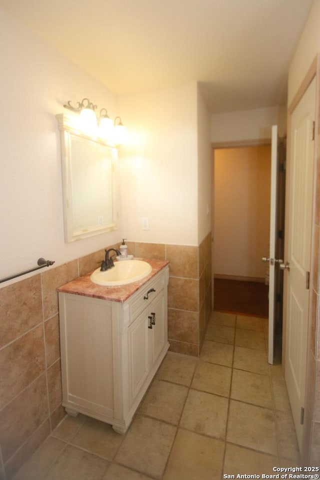 3084 Rustler, Canyon Lake, TX 78133 - bathroom featuring vanity, tile walls, tile patterned flooring, and wainscoting