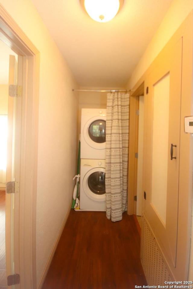3084 Rustler, Canyon Lake, TX 78133 - clothes washing area with estacked washer and dryer, wood finished floors, and baseboards