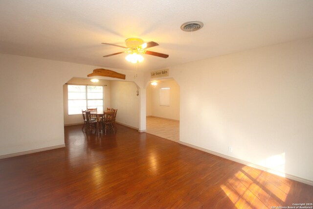 3084 Rustler, Canyon Lake, TX 78133 - empty room with arched walkways, a ceiling fan, wood finished floors, and baseboards