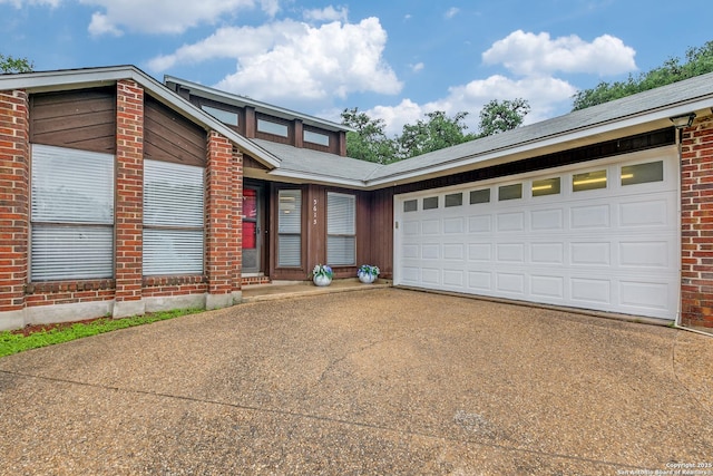 5615 Timber Bark, San Antonio, TX 78250 - mid-century home with concrete driveway, brick siding, and an attached garage
