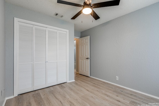 5615 Timber Bark, San Antonio, TX 78250 - unfurnished bedroom with wood finished floors, a closet, and baseboards
