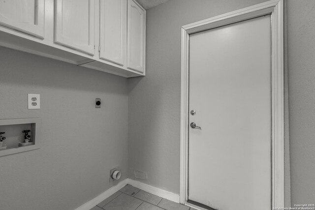 5615 Timber Bark, San Antonio, TX 78250 - laundry area with electric dryer hookup, hookup for a washing machine, cabinet space, light tile patterned floors, and baseboards