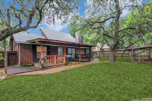 5615 Timber Bark, San Antonio, TX 78250 - back of house with a chimney, brick siding, and a wooden deck