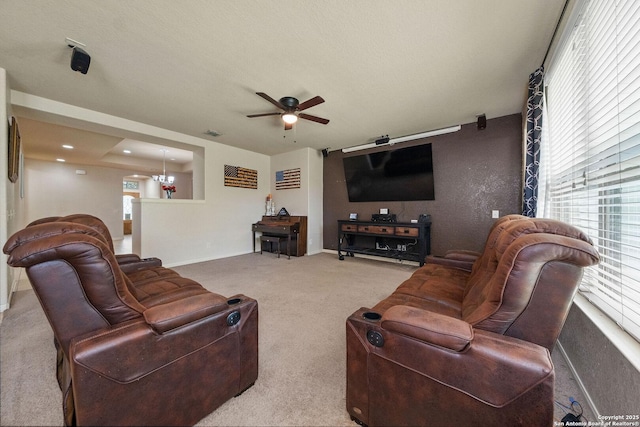 living room with ceiling fan, carpet flooring, and baseboards