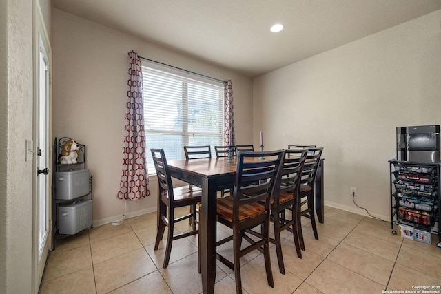 dining space with light tile patterned flooring, baseboards, and recessed lighting