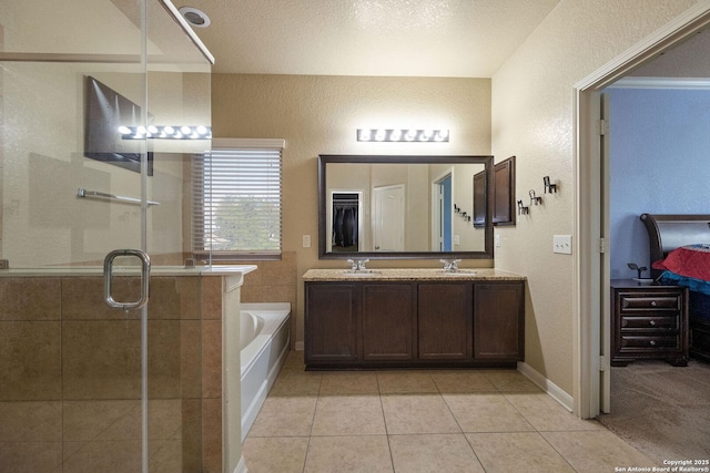 12602 Fiesta, San Antonio, TX 78245 - bathroom with a garden tub, a stall shower, tile patterned floors, a textured wall, and double vanity