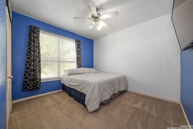 bedroom featuring carpet floors, baseboards, and a ceiling fan