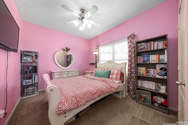 carpeted bedroom with baseboards and a ceiling fan