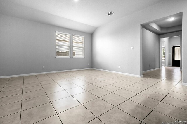 12466 Belfort Pt, Schertz, TX 78154 - empty room featuring light tile patterned floors, vaulted ceiling, and baseboards